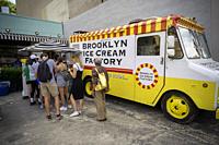 Visitors to the Dumbo neighborhood of Brooklyn in New York enjoy free mini-cones from the Brooklyn Ice Cream Factory on Sunday, August 11, 2019. Forme...