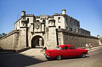Old American car used as taxi in front of the Castillo De La Real Fuerza-Castle in Old Havana, La Habana, Cuba, West Indies, Central America