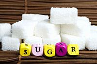 Sugar lumps and word sugar. Multicolored cubes.