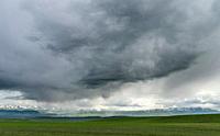 Thunderstorm over the Suusamyr plain, a high valley in Tien Shan Mountains. Asia, central Asia, Kyrgyzstan.