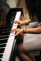 Young girl playing the piano.