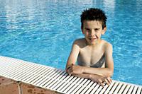 Child in swiming pool. Blue glasses.