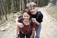 Mature woman and teenager walking on a path in the forest. Bad Tölz, Upper bavaria, Germany.