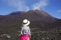 Woman looks at Mount Etna, Sicily, Italy.