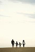 Family walking on the beach.