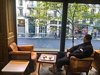 Paris, France, Chinese Tourist Relaxing, Sitting Alone at Table, Inside Window, French Cafe in Latin Quarter, .