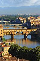High view along the Arno river to the Ponte Vecchio, the old bridge. Florence, Tuscany, Italy. The historic centre of Florence is a UNESCO World Herit...