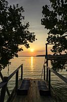 view from rustic wood sun deck on Koh Ta Kiev island near Sihanoukville in Cambodia at sunset.