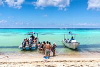Playa Palancar, Mexico - April 24, 2019: Tourists boating on an empty Palancar beach in Playa Palancar, Quintana Roo, Mexico.