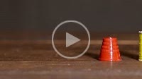 Colorful plastic spools of sewing threads with sewing needle and red thimble with yellow ribbon time lapse