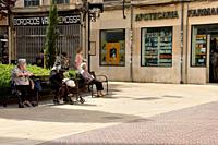 Elderly people sitting on public benches in Palma de Mallorca, Spain