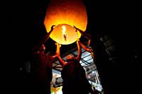 Bangladesh - October 13, 2019: Buddhist devotees people are trying to flying paper lanterns on the occasion of Probarona Purnima festival in Bandarban...