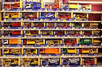 Shop toys. Toy store. Inside toy shop. Rows of shelves with toys. Children's joy. Wide selection of toys in children's store. Shop for children. Cars ...