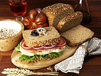 homemade chicken and vegetables wholemeal bread sandwich with ingredients in wood table background.