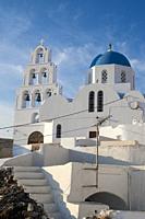 typical white church with blue dome in Santorini island, greece.