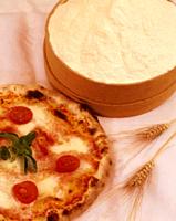Margherita and cherry tomato pizza photographed with spikes and flour. Sicilin food.