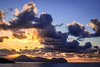 Sunset over Tyrrhenian Sea seen from Zafferano cape near Santa Flavia on Sicily Island in Italy, Gallo cape and Pellegrino mount on background.