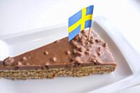 Daim chocolate cake with the flag of Sweden. Closeup.