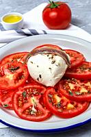 Healthy Homemade Tomato Salad with Mozzarella, Anchovies and Oregano. Healthy food concept.