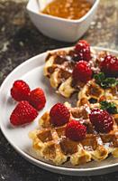 Waffle with cream raspberries and chocolate strawberries. Homemade.