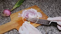 Cook´s hands cutting onion