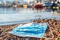 BECICI ANDi BUDVA, BUDVA MUNICIPALITY, MONTENEGRO - JULY 31, 2020: During the COVID-19 pandemic, used medical face masks pollute European beaches, the...