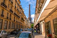 France. Summer Paris. Sunny day. Many cars on the narrow street. Eiffel Tower in the background.