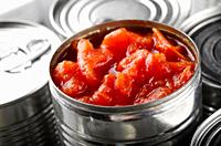 Canned sliced tomatoes in just opened tin can. Non-perishable food.