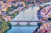 Aerial view of Triana (foreground) and San Telmo (background) bridges over the Guadalquivir river, Seville, Spain. High resolution vertical panorama.