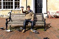 A Local Man Feeding The Pigeons, High Street, Lewes, East Sussex, UK.