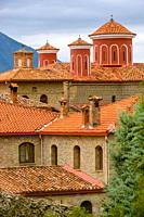 Greece. Summer nasty day in Meteora. Red roofs and crosses on a greek monastery.