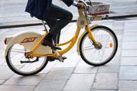 Italy, Lombardy, Milan, Businessman Riding on a Rental Bike.