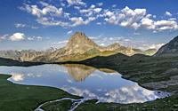 Midi d'Ossau peak reflecting into Gentau lake, Pyrenees national park, France