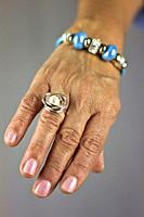 Detail of ring put on the hand of an older woman with wrinkles.