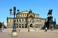 Tourists in front of the Opera House Semperoper on the Theatre Square in Dresden - Germany. .