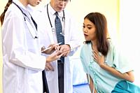 Patient fell worried while doctors explain about her health situation.