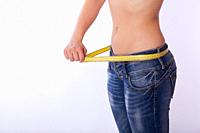 woman in jeans with a tape measure.