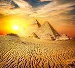 Egyptian pyramid in sand desert and clear sky.