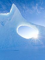 Iceberg frozen into the sea ice of the Uummannaq fjord system during winter in the the north west of Greenland, far beyond the polar circle. North Ame...