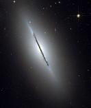 GALAXY NGC 5866 -- Feb 2006 -- This is a unique view of the disk galaxy NGC 5866 tilted nearly edge-on to our line-of-sight. Hubble's sharp vision rev...