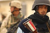 IRAQ Tal Afar -- 02 Feb 2006 -- A member of the Iraqi Police Force and a US Army soldier with the 3rd Armoured Cavalry Regiment conduct a joint combat...