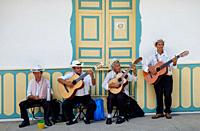 A quartet of street musicians perform for tourists in Salento, Colombia.