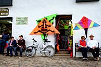 Tourists relax in front of a kite shop in Villa de Leyva, Colombia's Plaza Mayor. August is kite-flying season in Colombia.