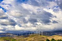 Spectacular heaven over the mountains with windmills for renewable energy. High quality photography.