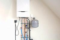 New gas boiler, Heating system with copper pipes, valves and other equipment in a boiler room gas heater system, modern in new house white wall.