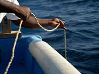 Fisherman Hands PICK UP the rope of the fishing cage, Dominican Republic