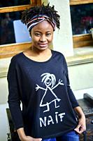 Young african woman with an cool hair style and a t-shirt posing outdoor.