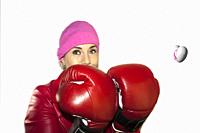 Woman in red leather jacked made up looking at the camera wearing pink kerchief and box gloves, with a happy gesture and positive attitude with a thre...