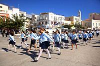 Schoolgirls during a ceremony at Tinos town or Chora, the capital and main harbour of Tinos Island, Cyclades Islands, Greek Islands, Greece, Europe.