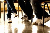 View of some teenager legs on a classroom.